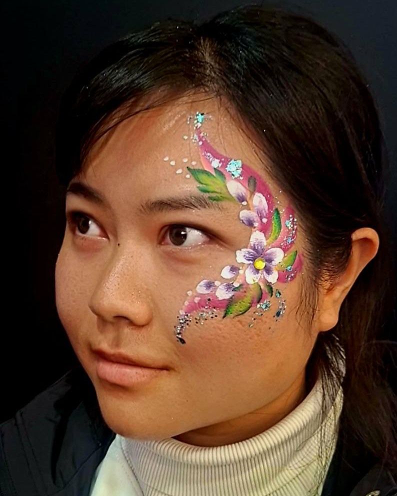 Pink flower and gem face design with green leaves