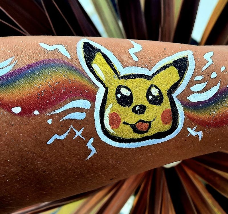 Pikachu arm painting with rainbow swirl
